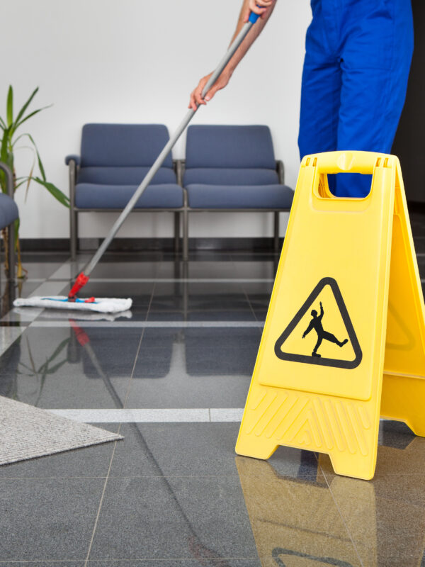 Close-up,Of,Man,Cleaning,The,Floor,With,Yellow,Wet,Floor