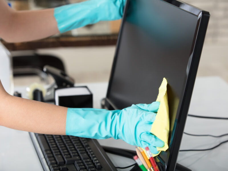 Close-up,Of,A,Woman's,Hand,Cleaning,The,Desktop,Screen,With